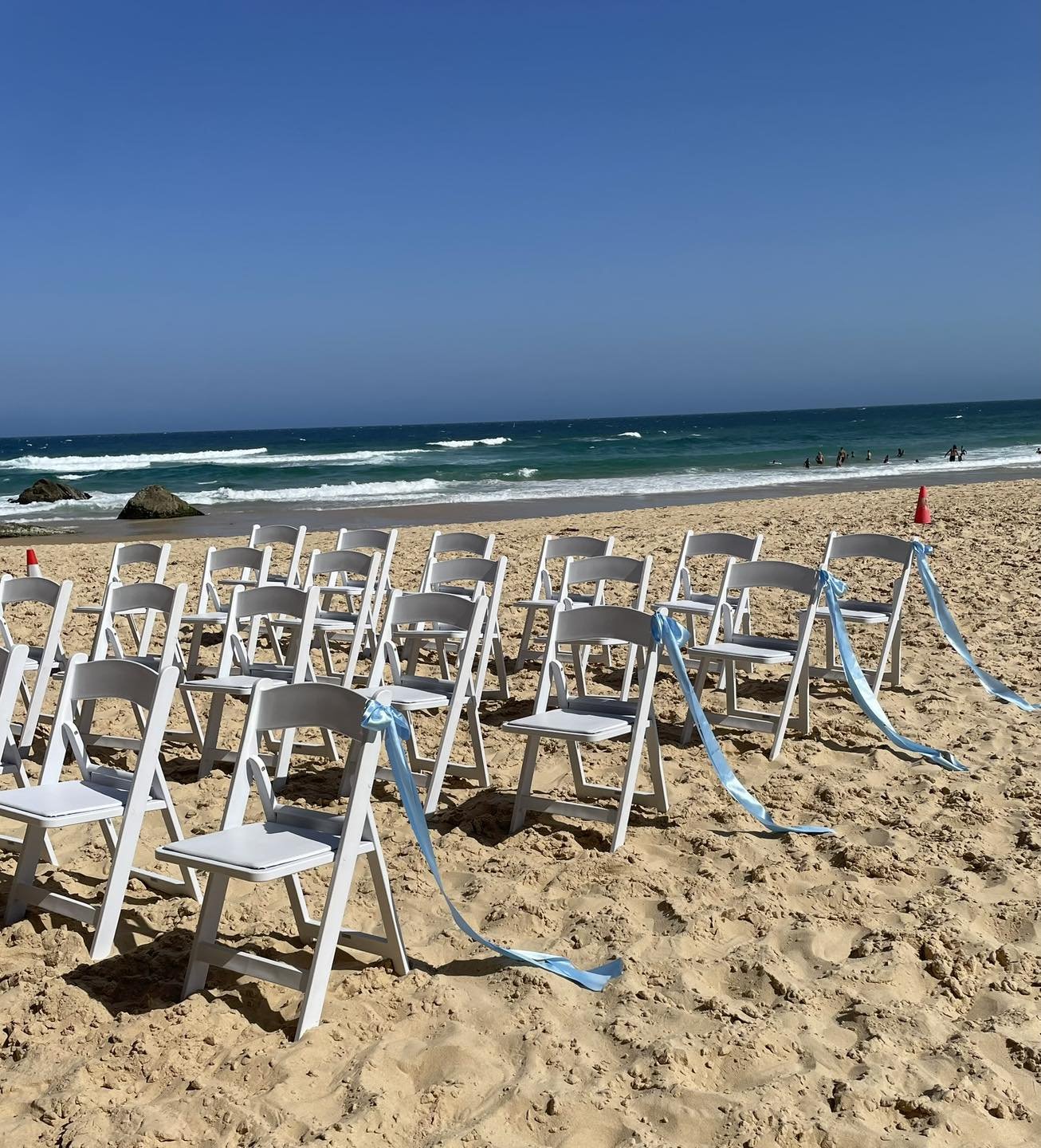 Beach ceremony at Redhead Beach with blue ribbons