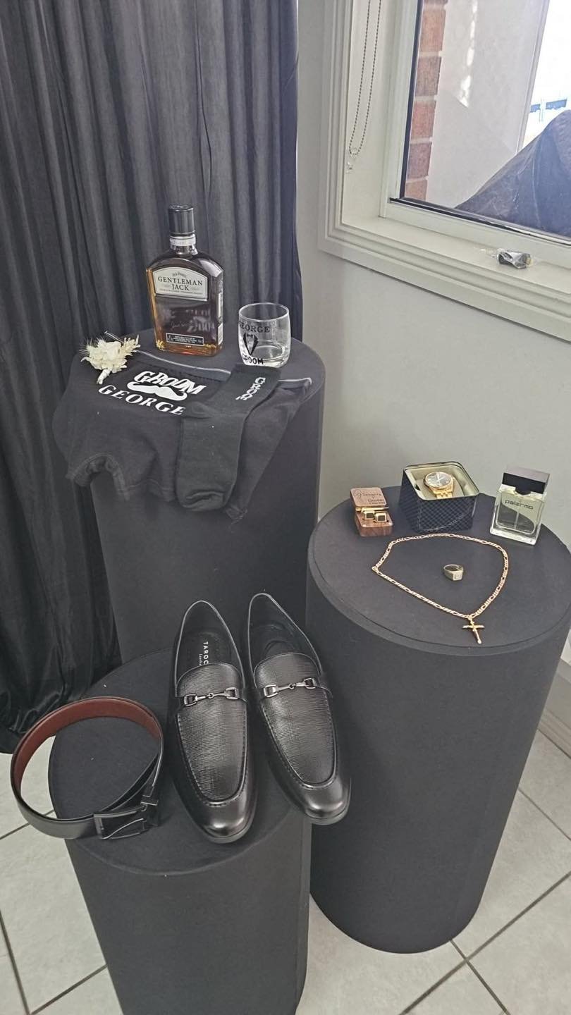 Groom room with personalised whisky, watch and shoes display