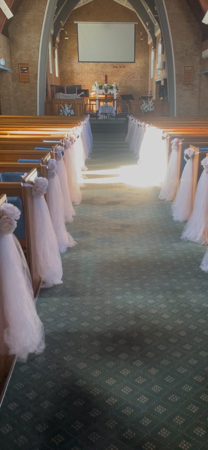 Church aisle with blush chair sashes